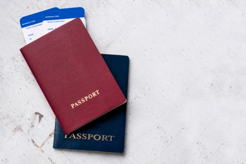 two-travelers-passports-red-blue-with-boarding-passes-plane